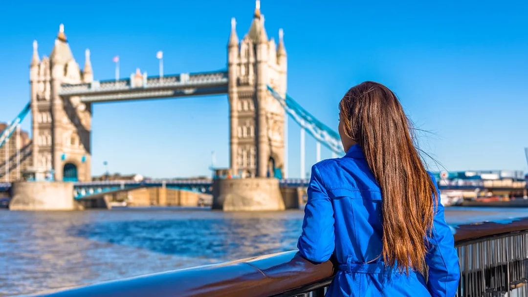 Woman overlooking Tower Bridge in London.