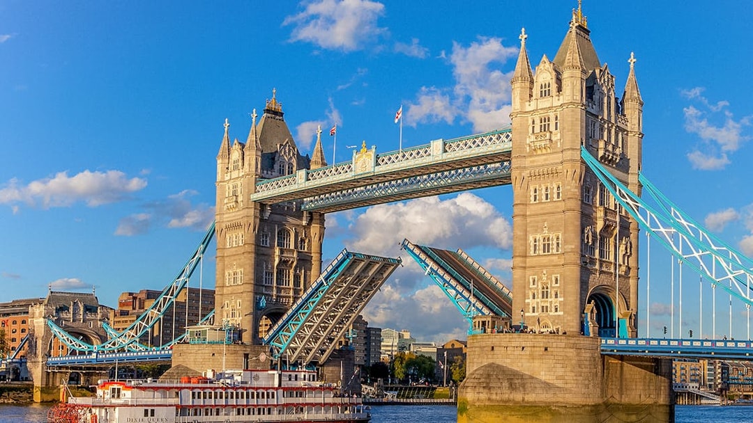 Tower Bridge in London with raised bascules, viewed from the River Thames.