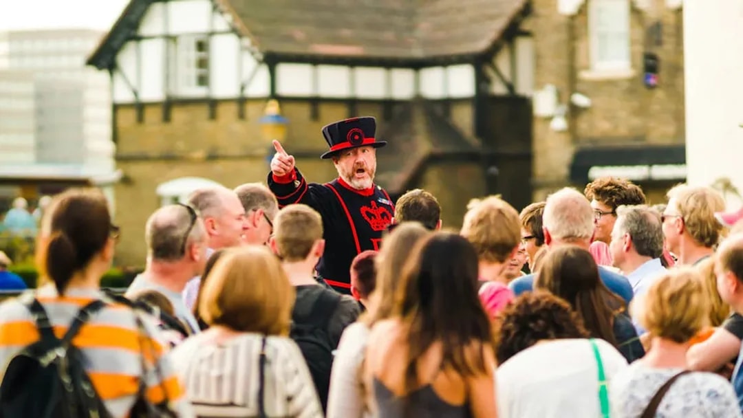 Beefeater guiding tourists at the Tower of London.
