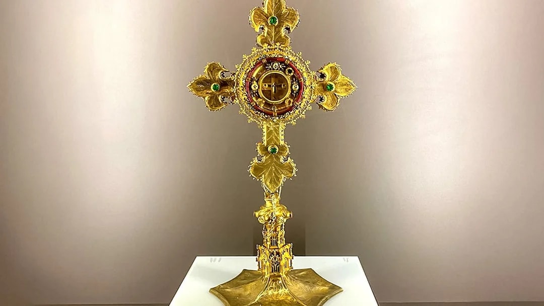 Golden cross with intricate design at St. George's Castle Church.