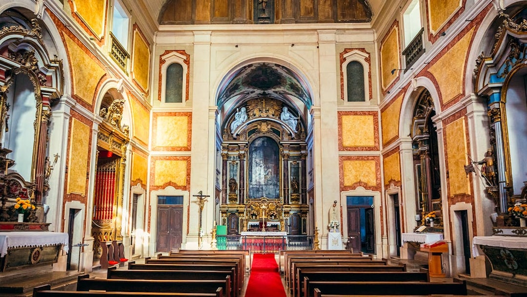 Interior of St George's Castle Church with ornate altar and pews, Lisbon, Portugal.