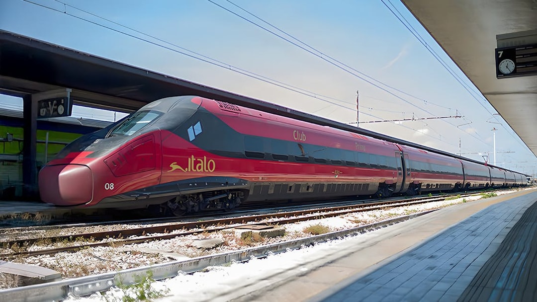 Italo train stationed at a platform in Italy.