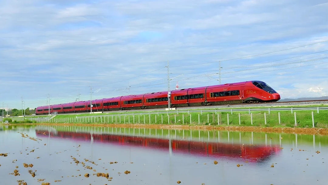 High-speed train traveling through countryside between Rome and Florence.