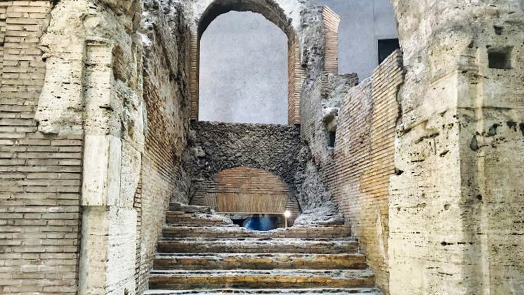 Ancient stone steps and archway in Rome's historic center.