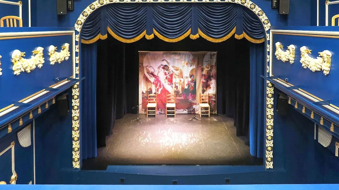 Triana Theater stage set for a flamenco show with decorative blue and gold interior.