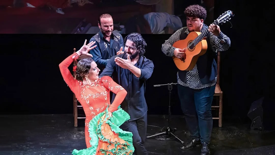 Flamenco dancers and guitarist performing at Teatro Flamenco Triana.