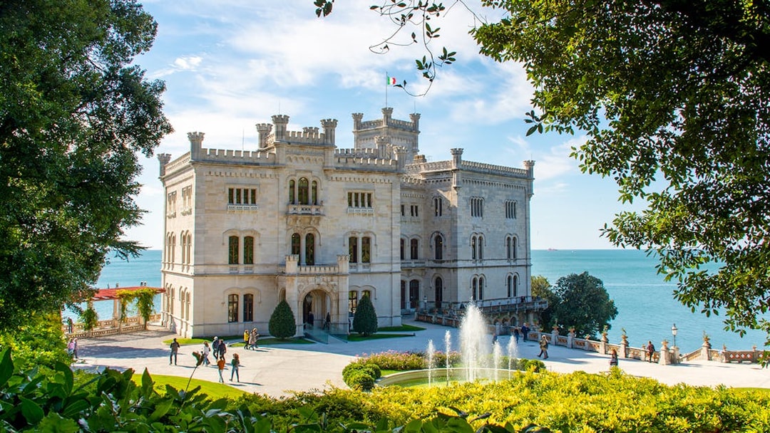 Miramare Castle with gardens and fountain overlooking the Gulf of Trieste on Hoptour.