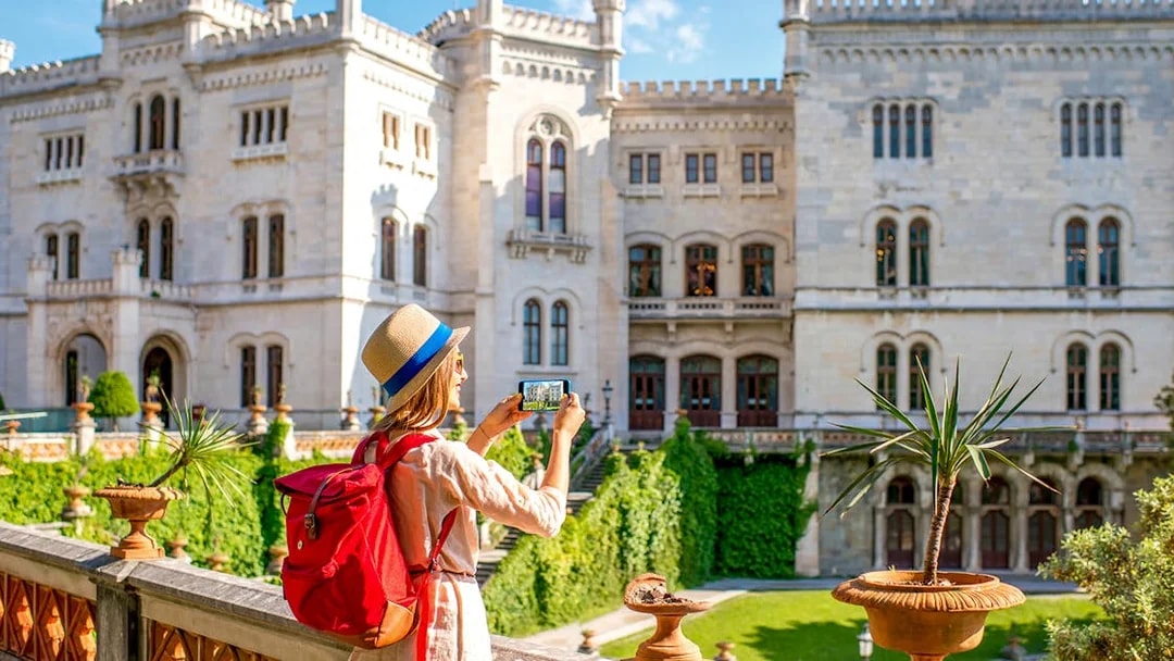 Visitor photographing Miramare Castle in Trieste during a private guided tour.