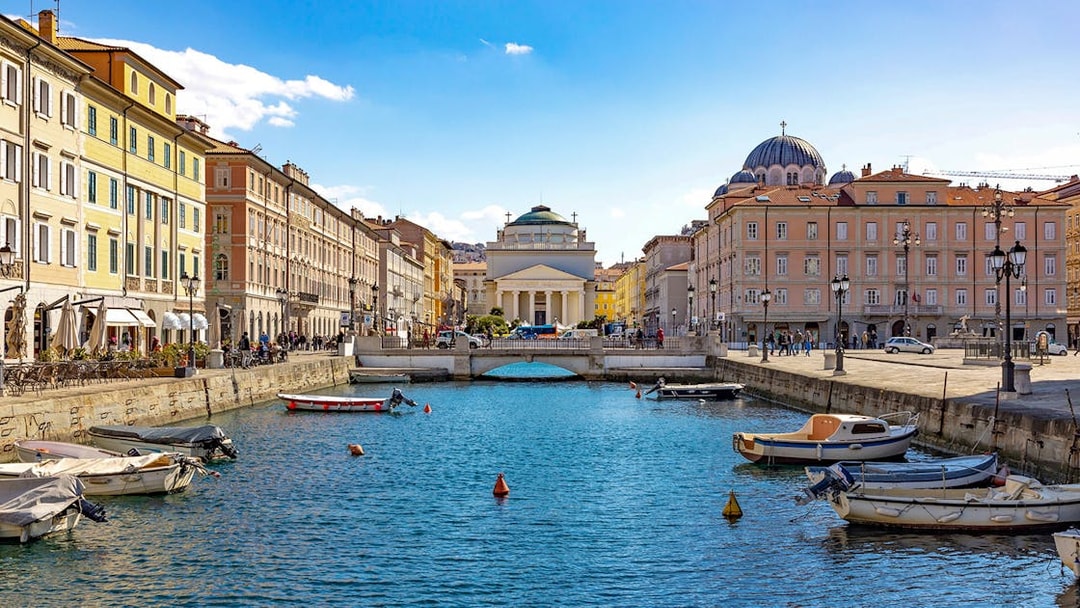 Trieste canal with boats and historic buildings on the Hoptour 24-hour hop-on hop-off route.