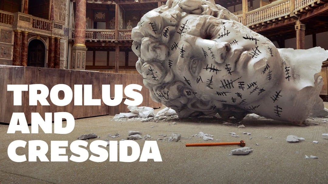 Giant head sculpture with tally marks in a theater setting, Troilus & Cressida.