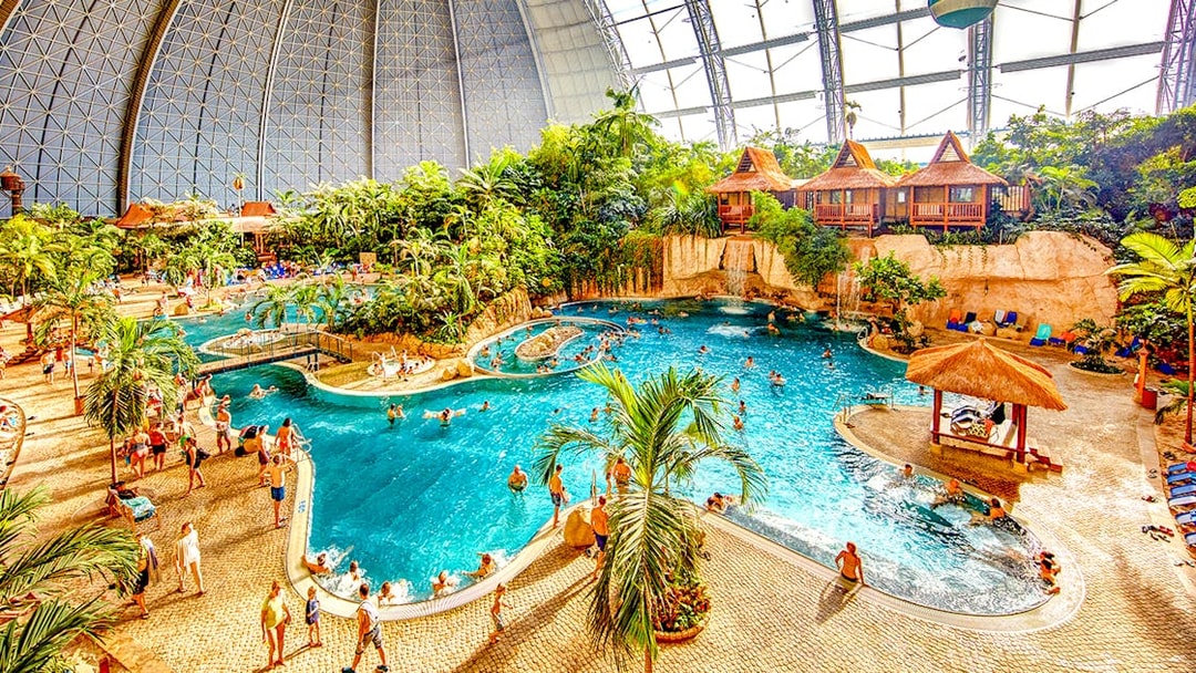 Indoor water park with pools and tropical plants at Tropical Islands Resort.