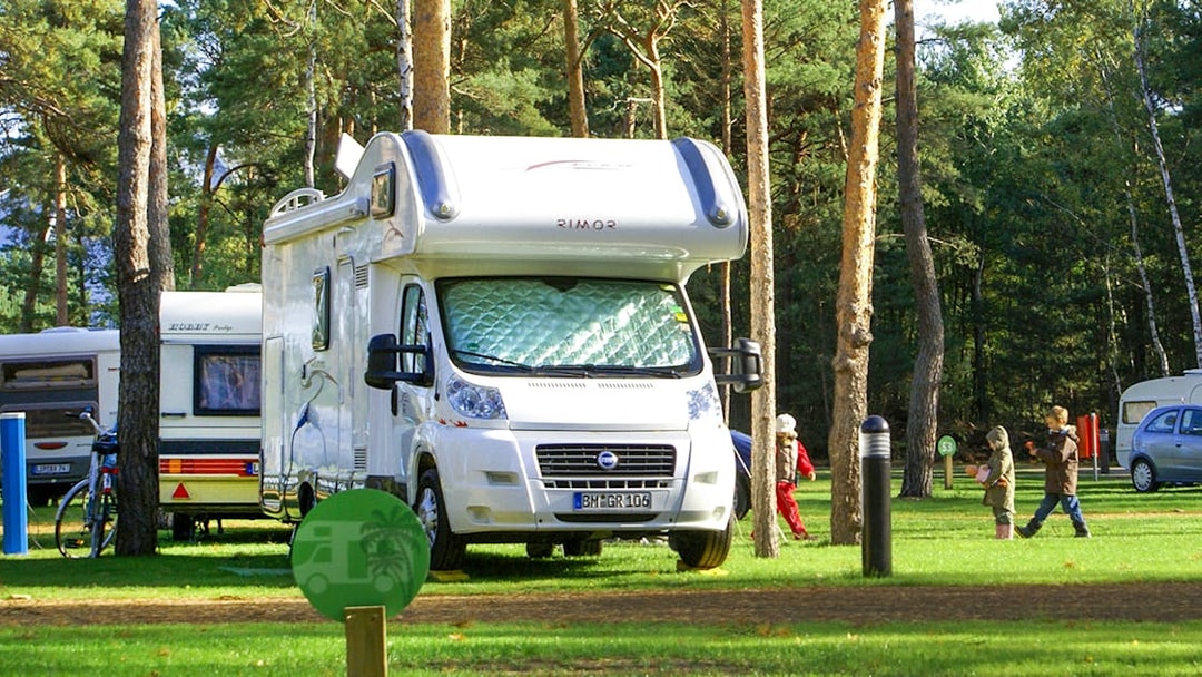 Campervan parked in a forested area at Tropical Islands Resort.