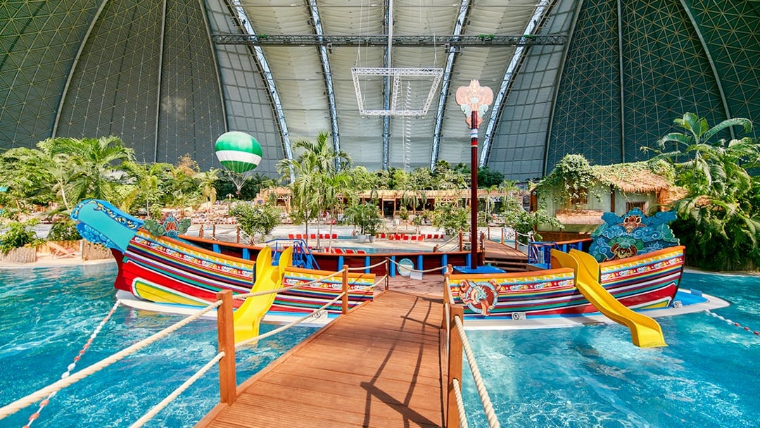 Colorful boat with slides in Tropical Islands Resort indoor water park.