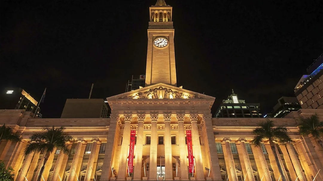 Brisbane City Hall illuminated at night, related to true crime stories tour.