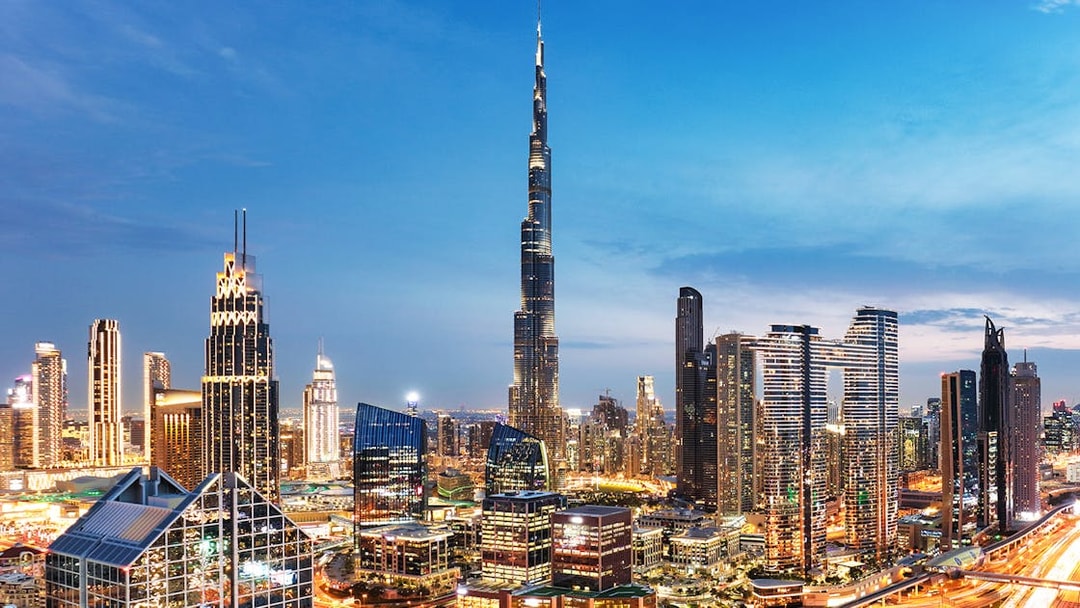 Dubai downtown skyline with Burj Khalifa and modern skyscrapers at dusk.