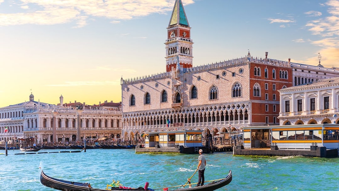 Gondola on Grand Canal with Doge's Palace in Venice, Italy.