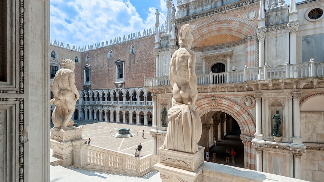 Doge's Palace courtyard in Venice, featuring statues and historic architecture.