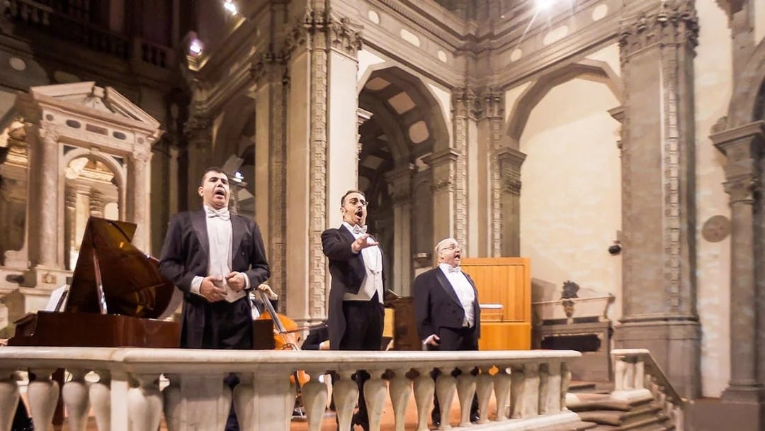 Three tenors performing in a historic Florence venue during a Tuscan dinner concert.