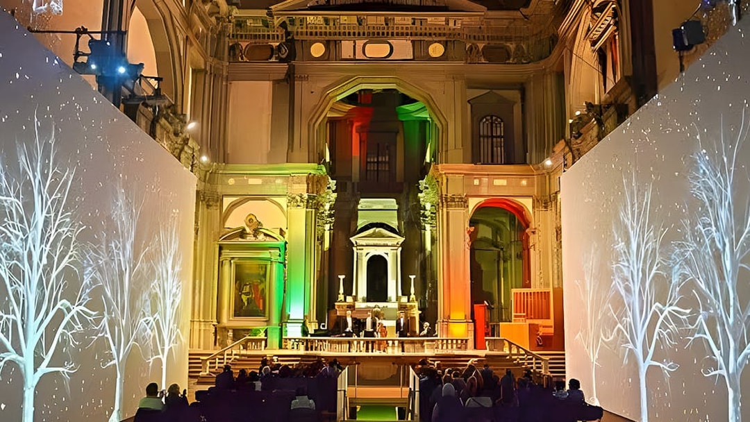 Three tenors performing in a historic Florence venue with illuminated decor.