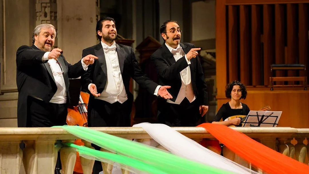Three tenors performing with a musician in Florence during a Tuscan dinner concert.
