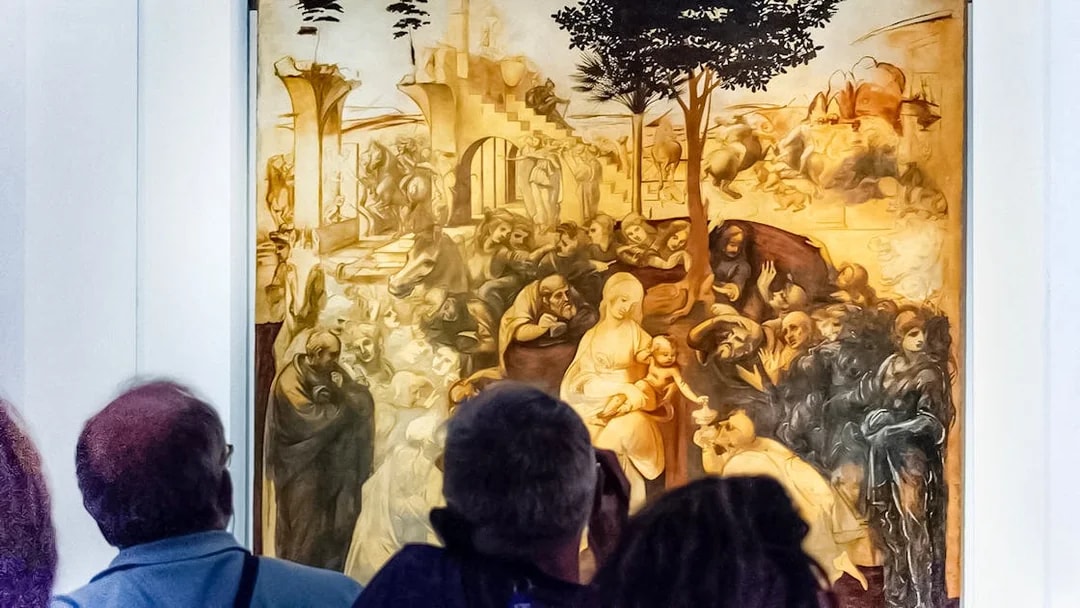 Visitors viewing Leonardo Da Vinci's "Adoration of the Magi" painting in a museum.