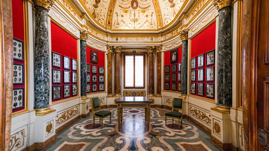 Art exhibits in a decorated room at the Uffizi Gallery, Florence, Italy.
