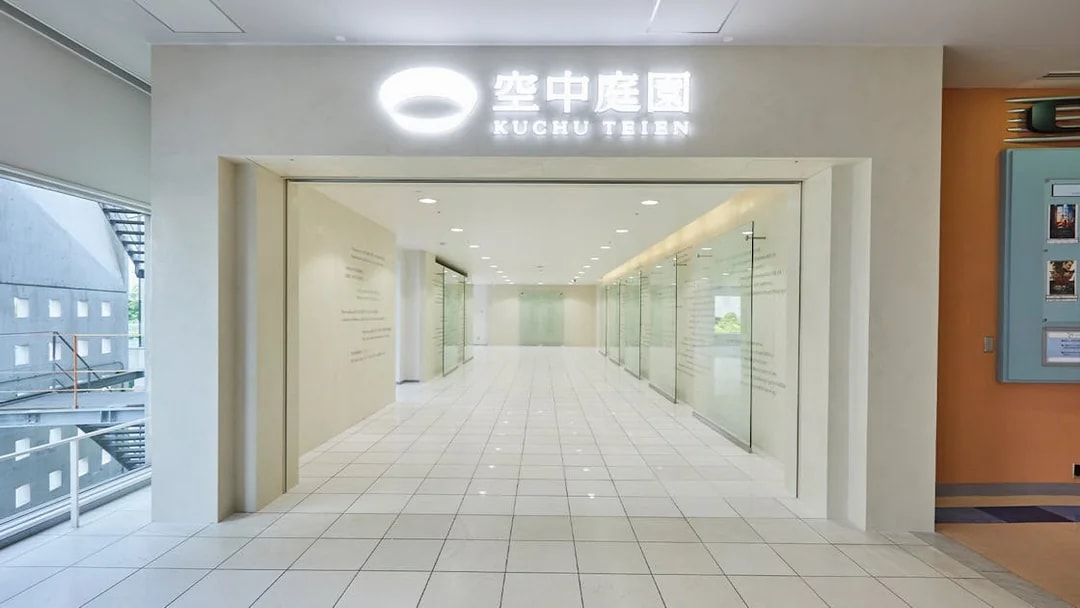 Umeda Sky Building interior hallway with glass walls and tiled floor, Osaka.