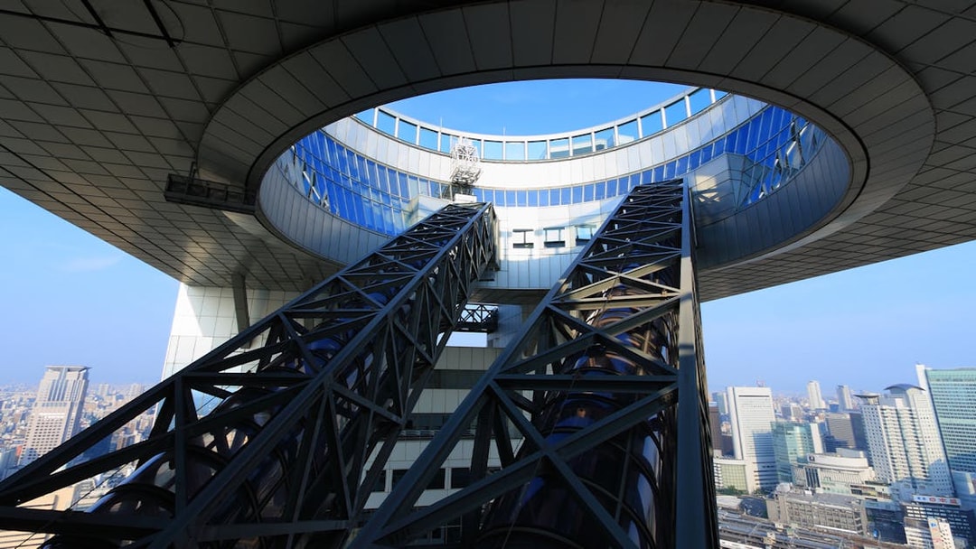 Umeda Sky Building escalators with Osaka cityscape in the background.