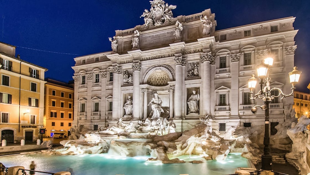 Trevi Fountain illuminated at night in Rome, Italy.