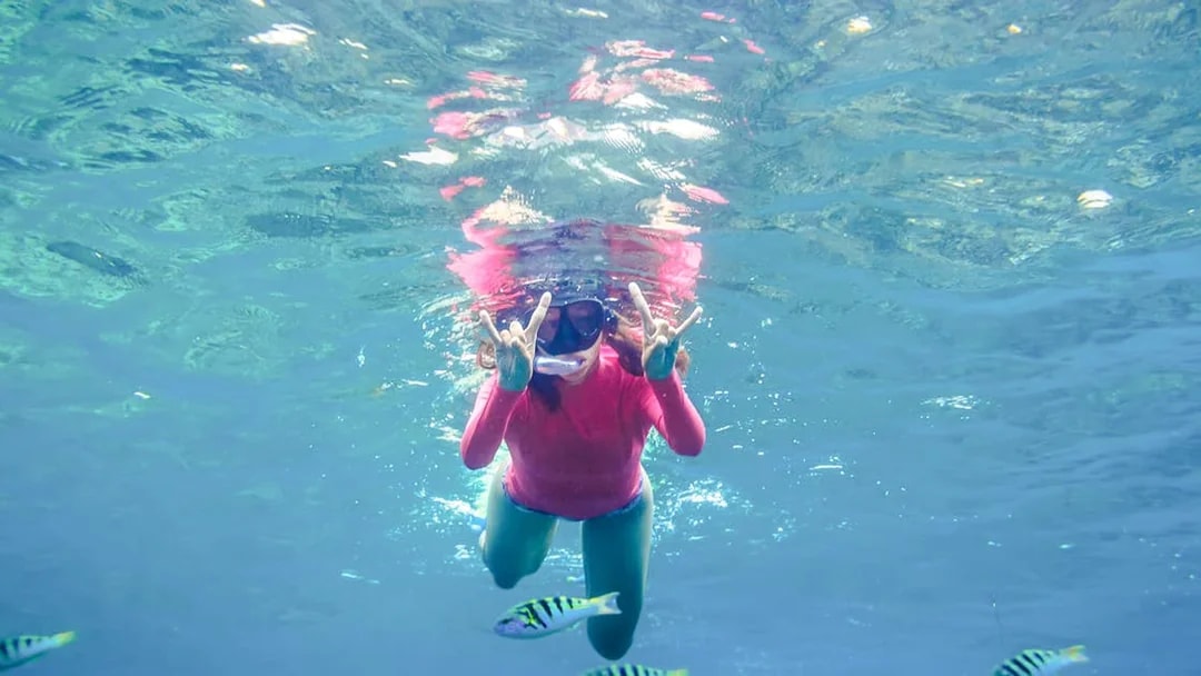 Girl snorkeling with fish in Saint-Jean-Cap-Ferrat, Nice, France.