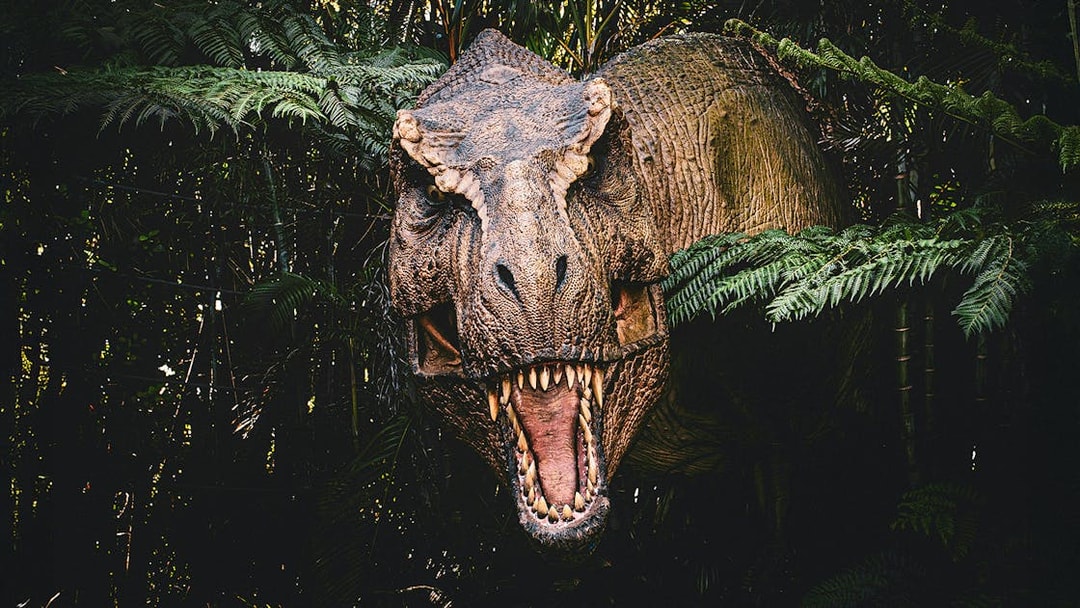 T-rex emerging from bushes at Jurassic Park attraction, Islands of Adventure, Universal Orlando.