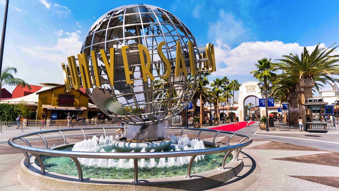 Universal Studios Hollywood entrance with iconic globe and fountain.