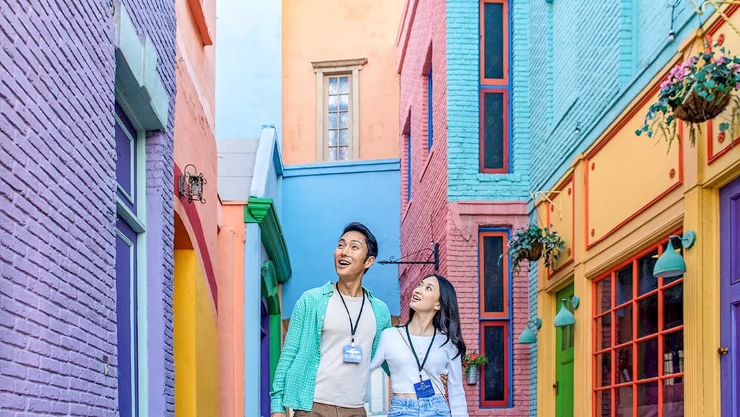Couple exploring colorful alley at Universal Studios Hollywood.