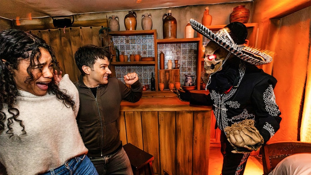 Guests reacting to a costumed performer at Hollywood Horror Nights, Universal Studios Hollywood, Los Angeles.