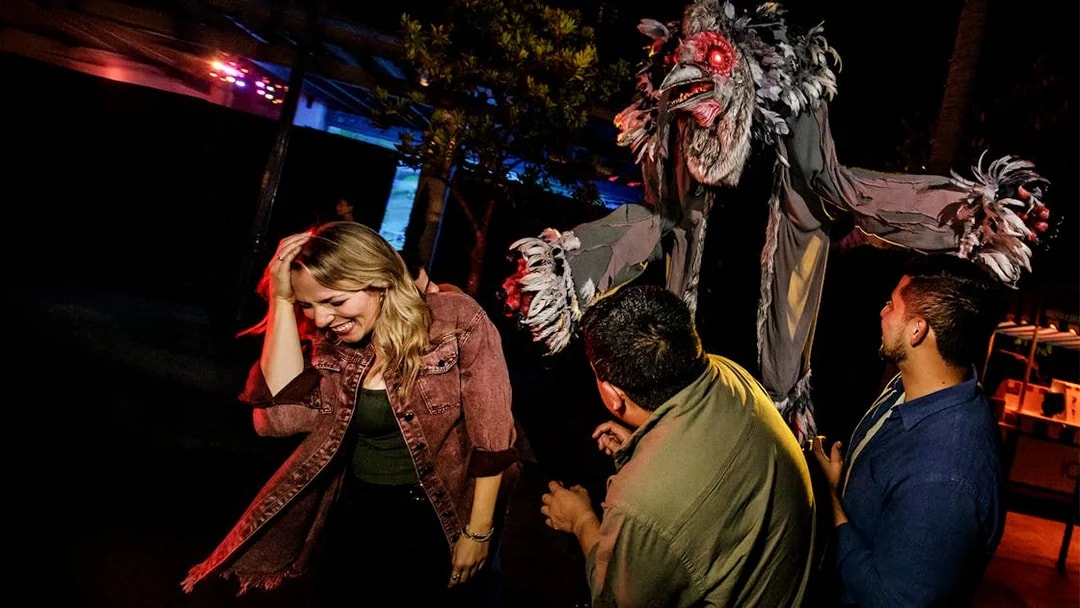 Guests reacting to a creature at Hollywood Horror Nights, Universal Studios Hollywood, Los Angeles.