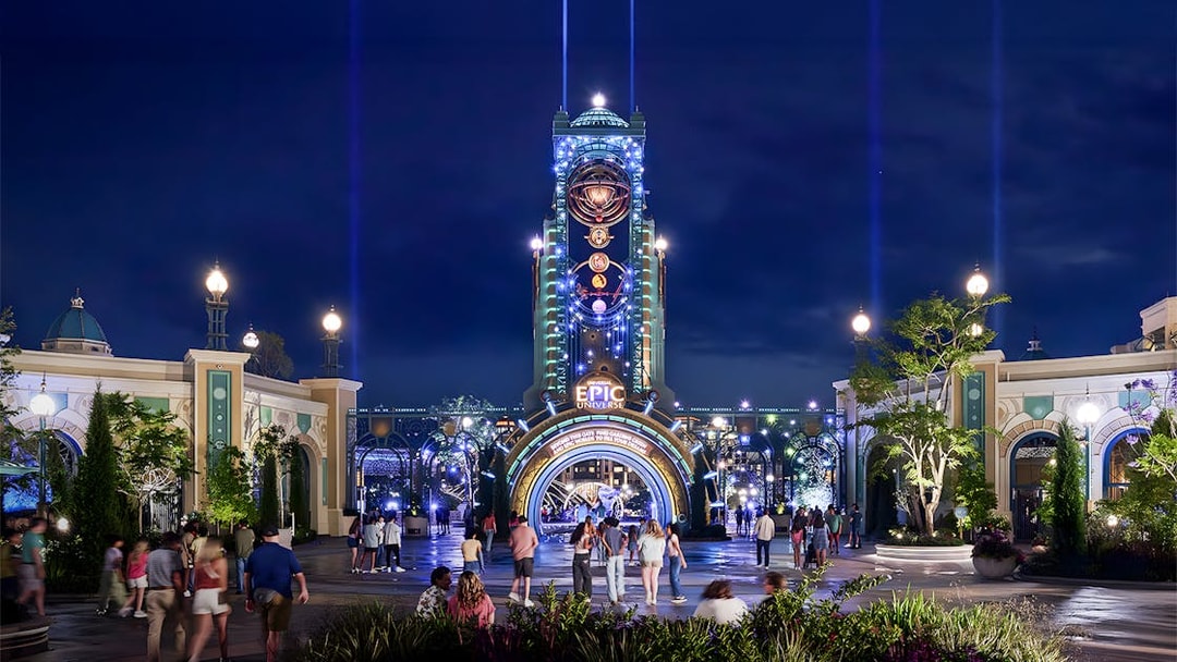 Guests entering Epic Universe park entrance at night, Universal Orlando, Florida.