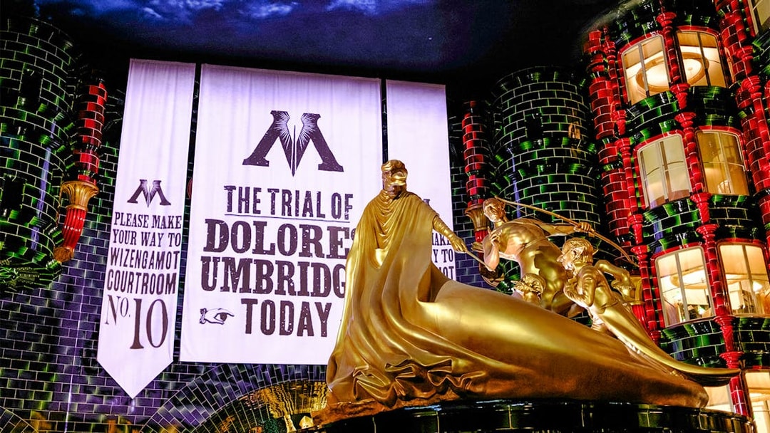 Trial banner and golden statue at Harry Potter and the Battle at the Ministry, Epic Universe, Orlando.