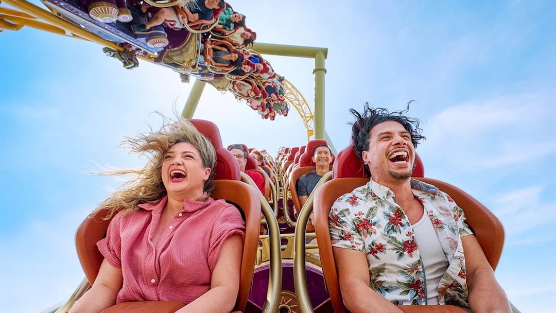 Thrill-seekers enjoying a rollercoaster ride at Epic Universe park, Universal Orlando, Florida.