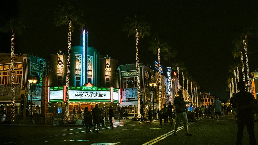 Universal Orlando's Horror Make Up Show marquee at night with illuminated street.