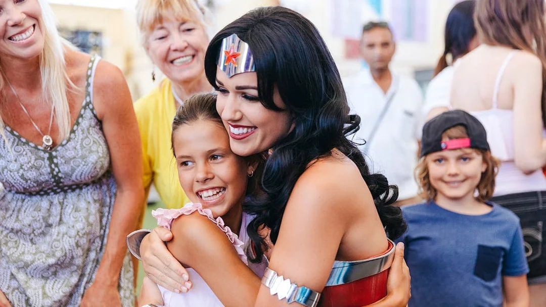 Wonder Woman character hugging a child at Warner Bros Movie World, Gold Coast.