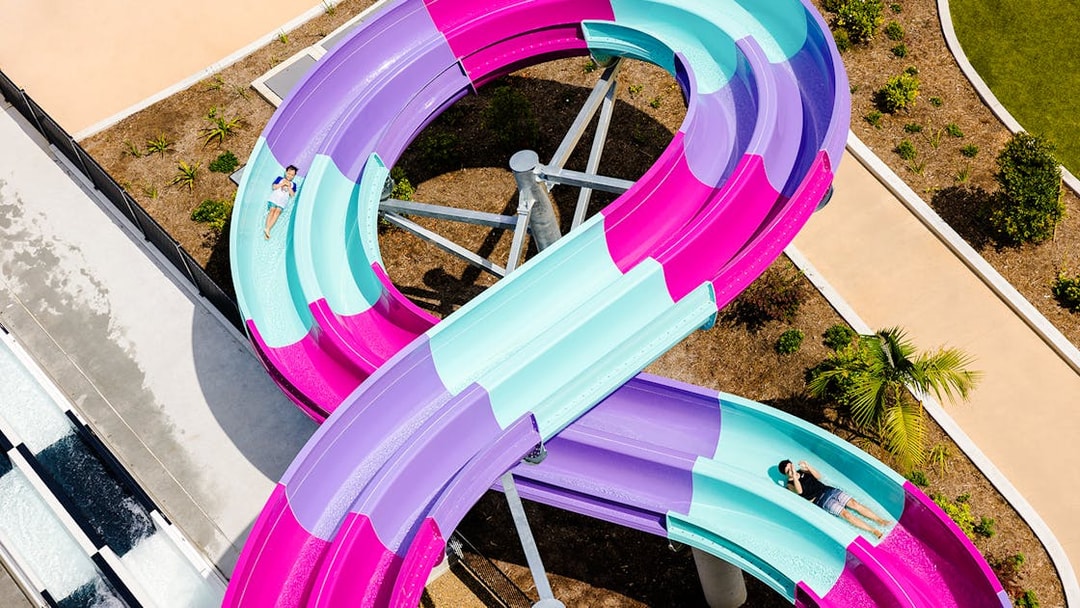 Colorful waterslide at Wet n Wild, Gold Coast with people sliding down.