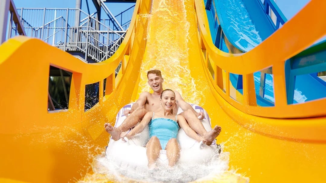 Couple enjoying Kaboom slide at Wet n Wild, Gold Coast waterslide.