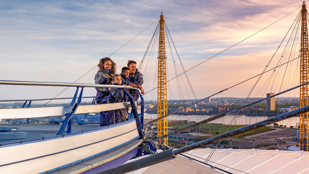 Guests enjoying the view from the O2 roof at sunset in London.