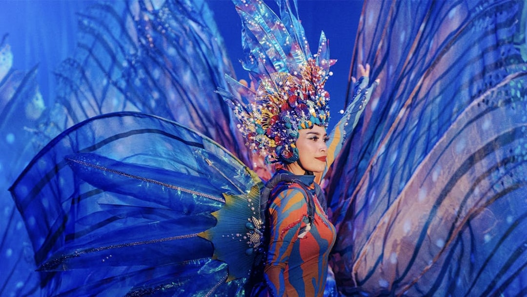 Performer in vibrant costume at Varuna Underwater Show, Bali Safari & Marine Park.