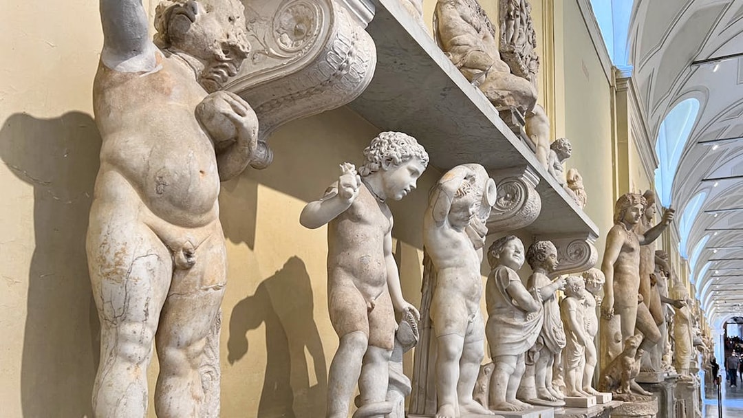 Marble statues in the Vatican Museums corridor, part of the skip-the-line tour.