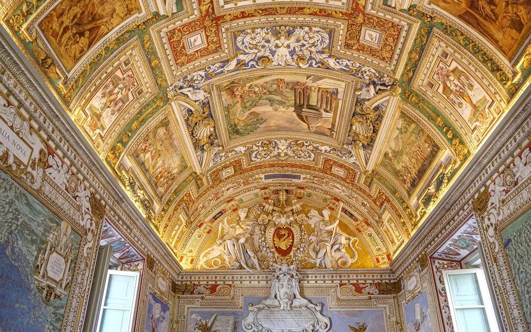 Vatican Museums ornate ceiling with detailed frescoes and sculptures, Vatican City.