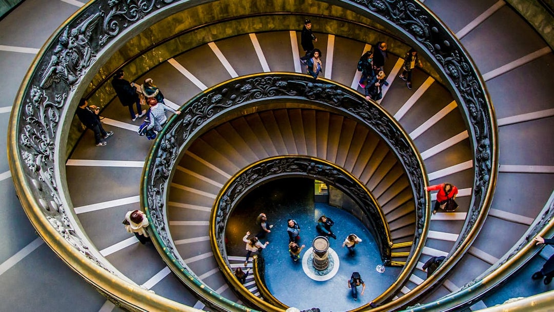 Tourists on the spiral staircase in Vatican Museums, part of the Sistine Chapel tour.