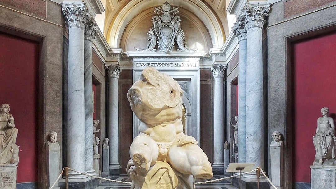 Belvedere Torso sculpture in the Vatican Museum's ornate gallery.