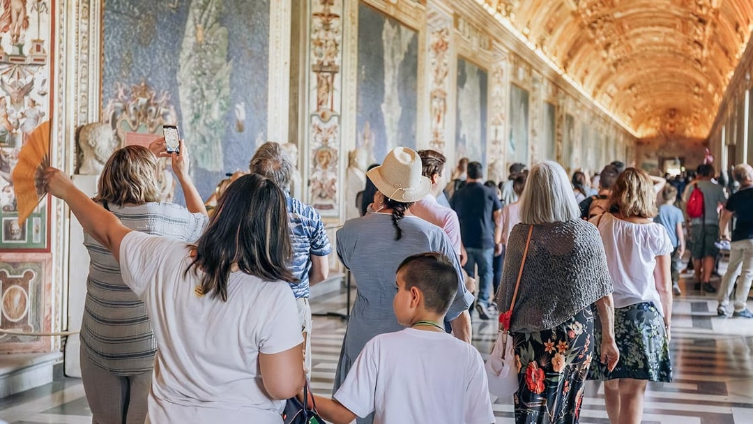 Visitors exploring the ornate halls of the Vatican Museums on a small group tour.