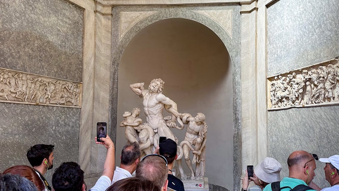 Tour group viewing Laocoön and His Sons statue in Vatican Museums.